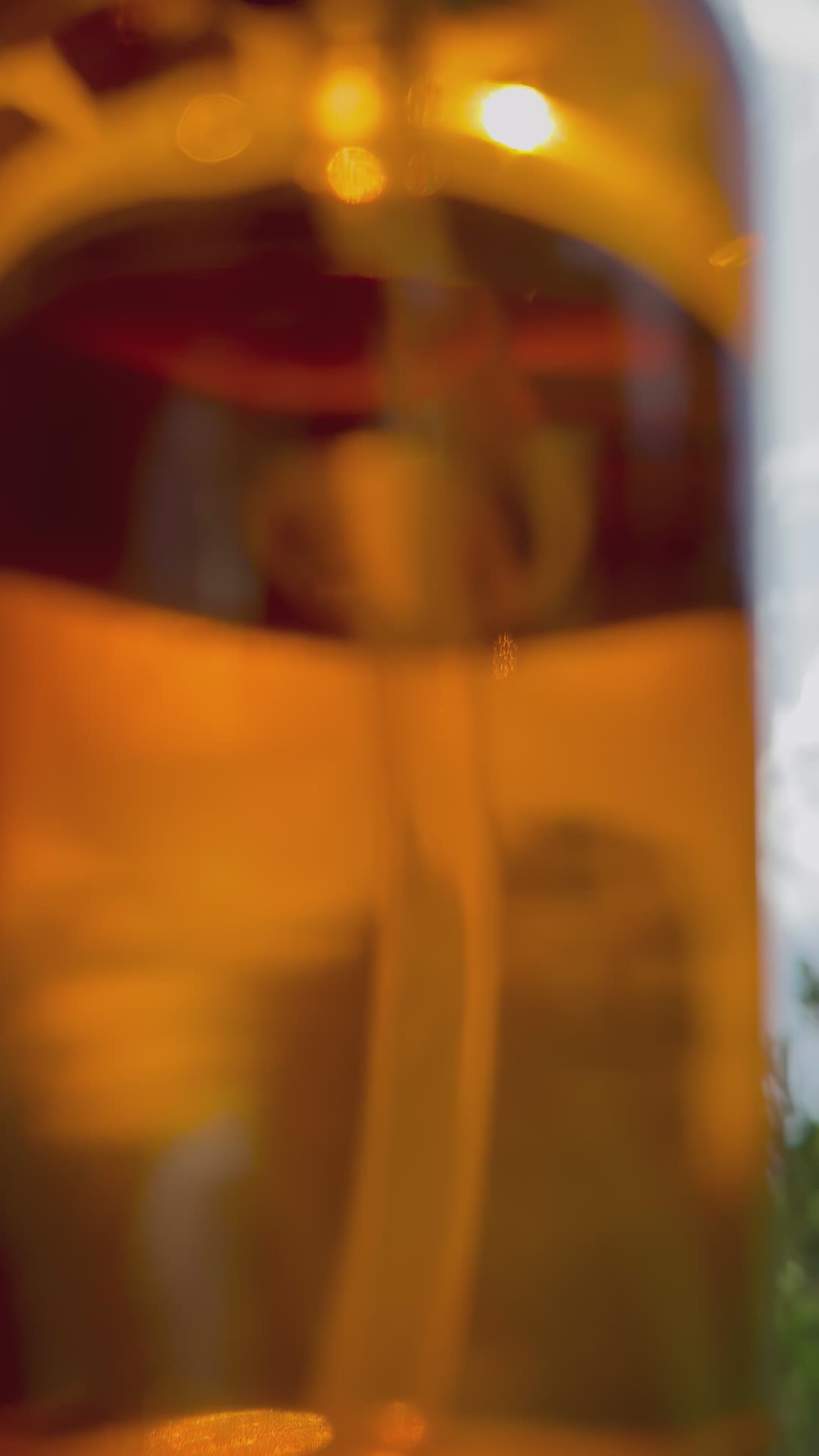 A bottle of clear Ambre, held up to the sun.